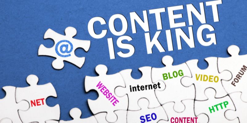 Jigsaw puzzle pieces with words like 'BLOG', 'SEO', 'CONTENT' on a blue background, symbolizing the integration of content marketing strategies.
